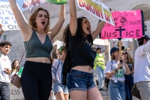 Aubrey Gilman (in the black t-shirt), 18, from UCLA, carries her "You turned the temperature hotter, now we’re burning up!" sign in the Youth Climate Strike at Los Angeles City Hall on Friday, March 15, 2019. Gilman said she came to the climate strike because, "Since the adults aren’t making a change, the students have to step in and do it for them." "Fridays for the Future" is organized by 16-year-old Swede Greta Thunberg. The Los Angeles Youth Climate March is organized by 17-year-old Los Angeleño Arielle Martinez-Cohen. (Glenn Zucman/The Corsair)